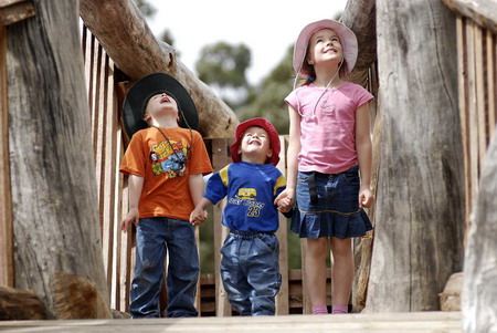 Children looking up at 'Hortisaurus' in the Kids' Backyard.