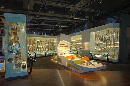 A number of display cases frame a display with a sign