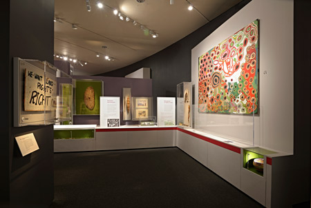 Placard from the Aboriginal Tent Embassy, set up outside Parliament House, Canberra, 1972. At right can be seen the collaborative painting used as the exhibition’s signature work, Kungkarangkalpa 