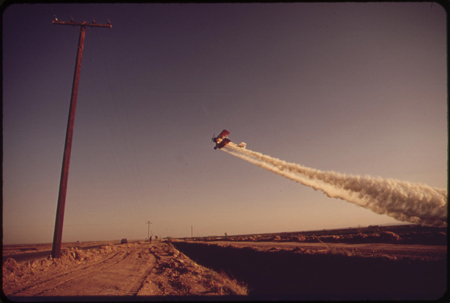 Crop duster plane flying over Imperial Valley farms