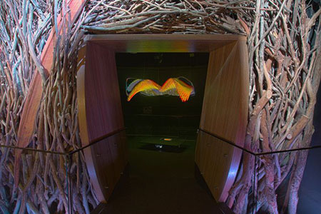 Sticks arranged around an archway frame an artwork.