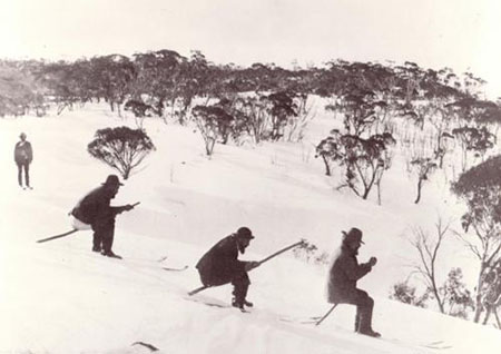 ‘Snowshoeing’, using round-ended poles held at an angle between the legs, acting as both seat and brakes, Kiandra, about 1900