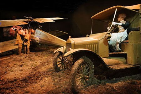 A nurse driving an ambulance in the set piece at Omaka depicting the crew of a Morane-Saulnier being pulled from their aeroplane.