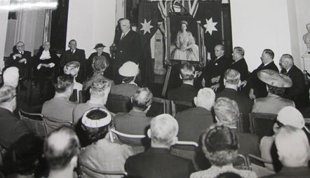 Photo of Prime Minister Robert Menzies and the 'Wattle Queen' portrait