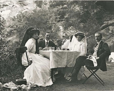 Photo of people sitting at a picnic table.